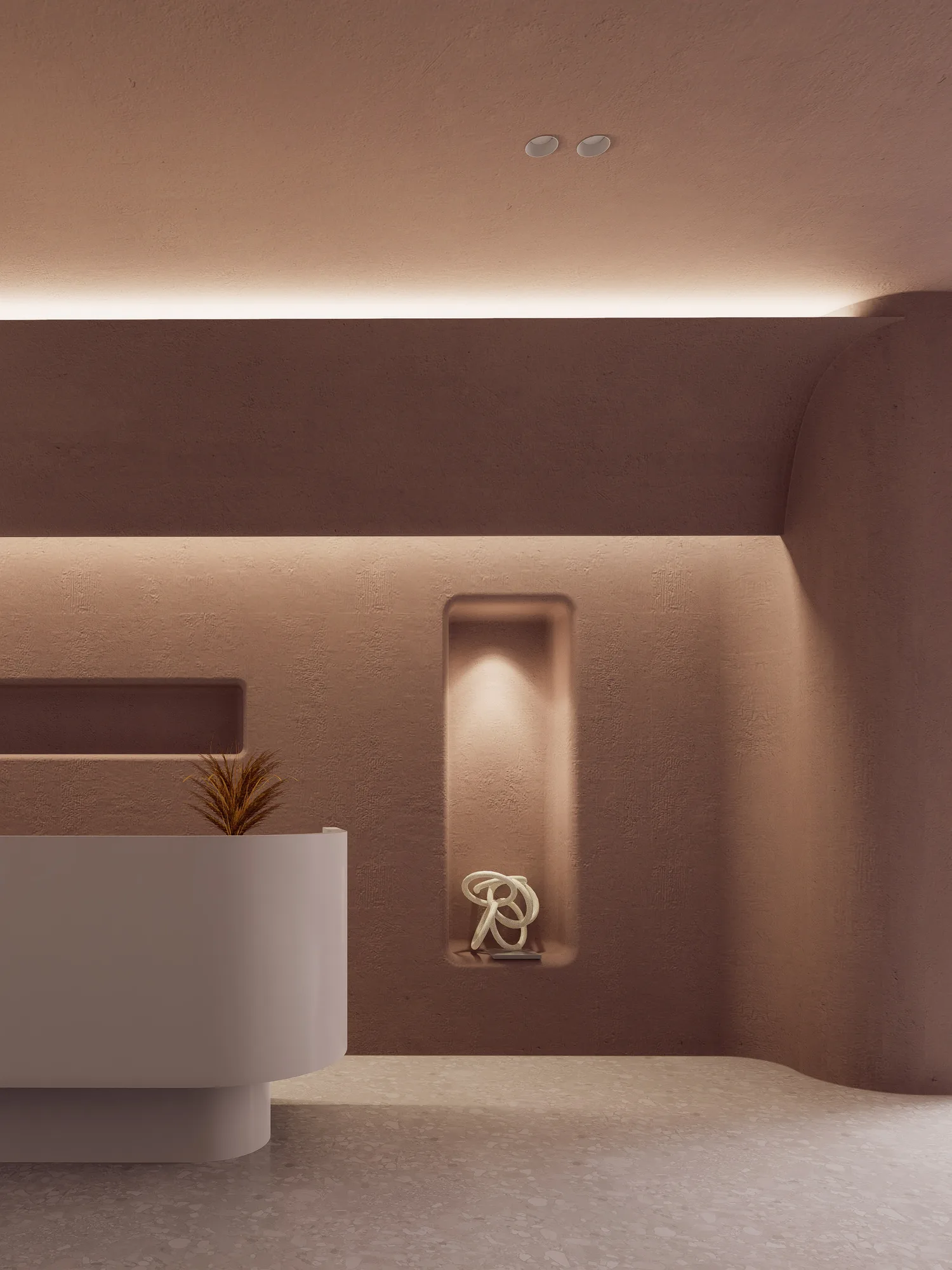 A recessed niche in Beauty Center's plaster wall holding a knotted rope sculpture, lit from a hidden cove above.