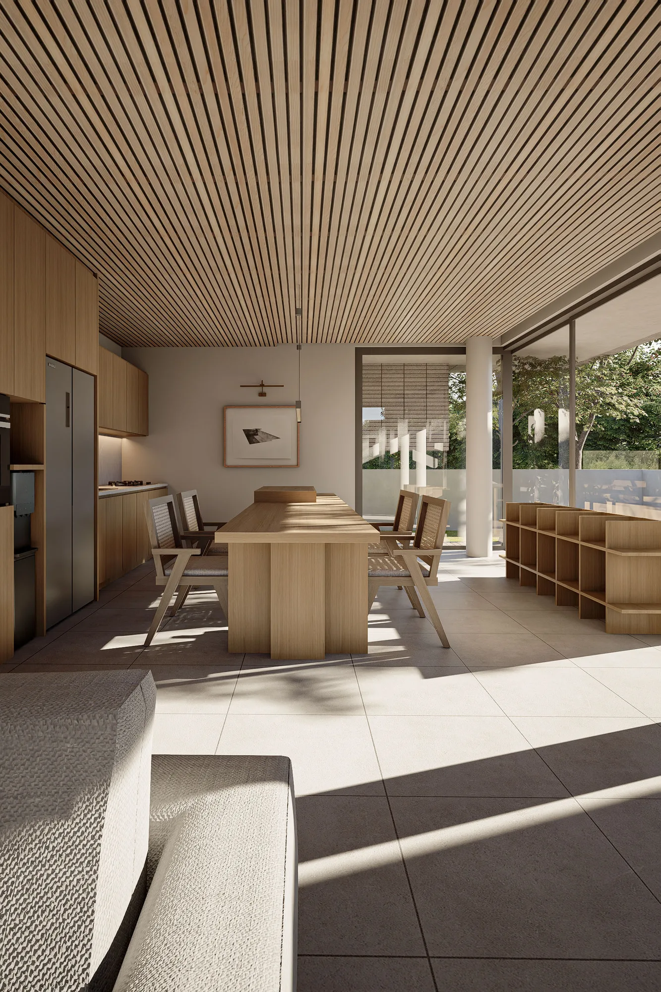 A concrete stair rises beside timber-slat cladding from the living room, past the kitchen's stainless appliances toward the upper floor.