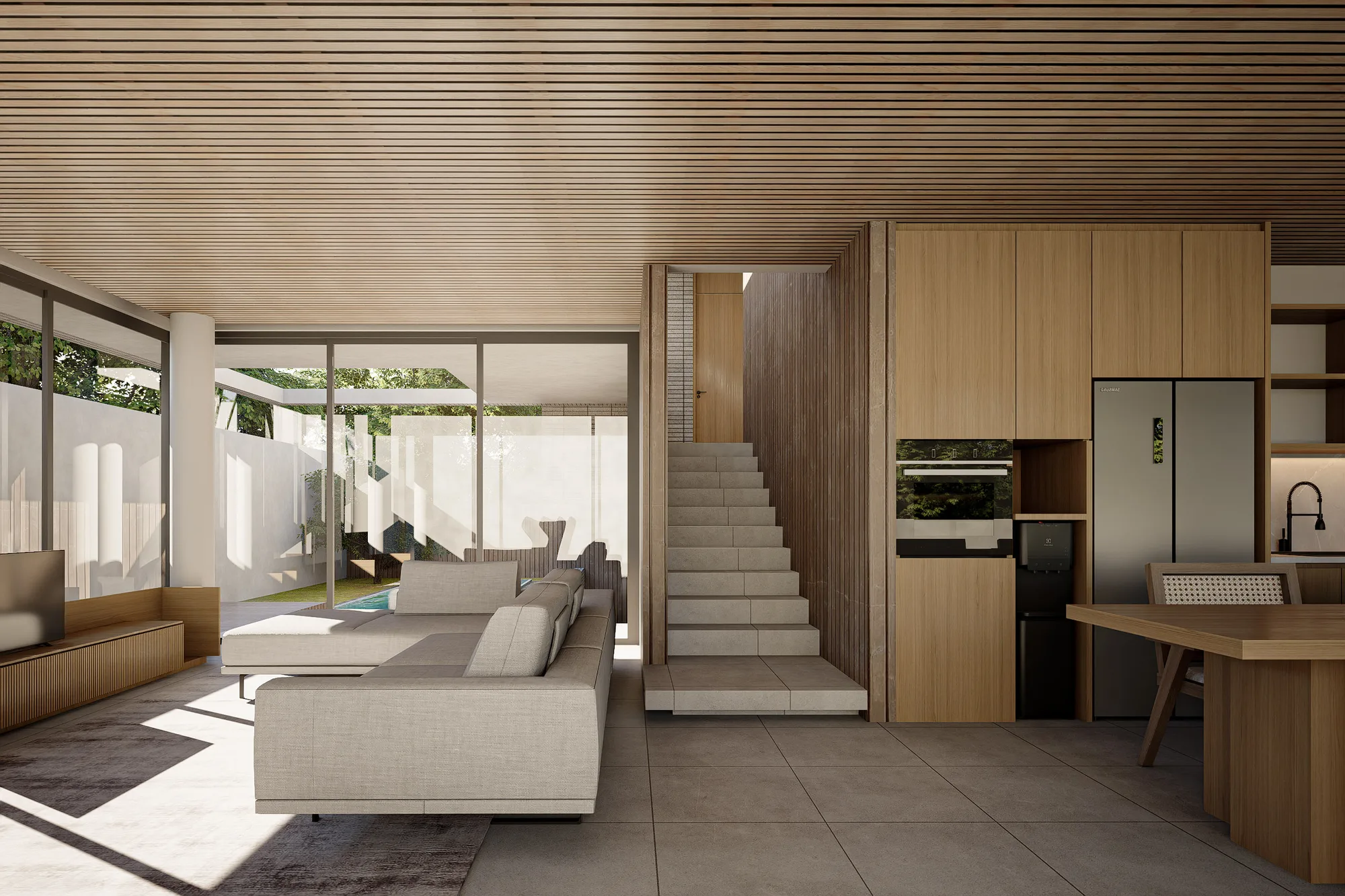 Oak cabinetry lines the kitchen, a linear pendant light hanging above the island beside the built-in refrigerator.