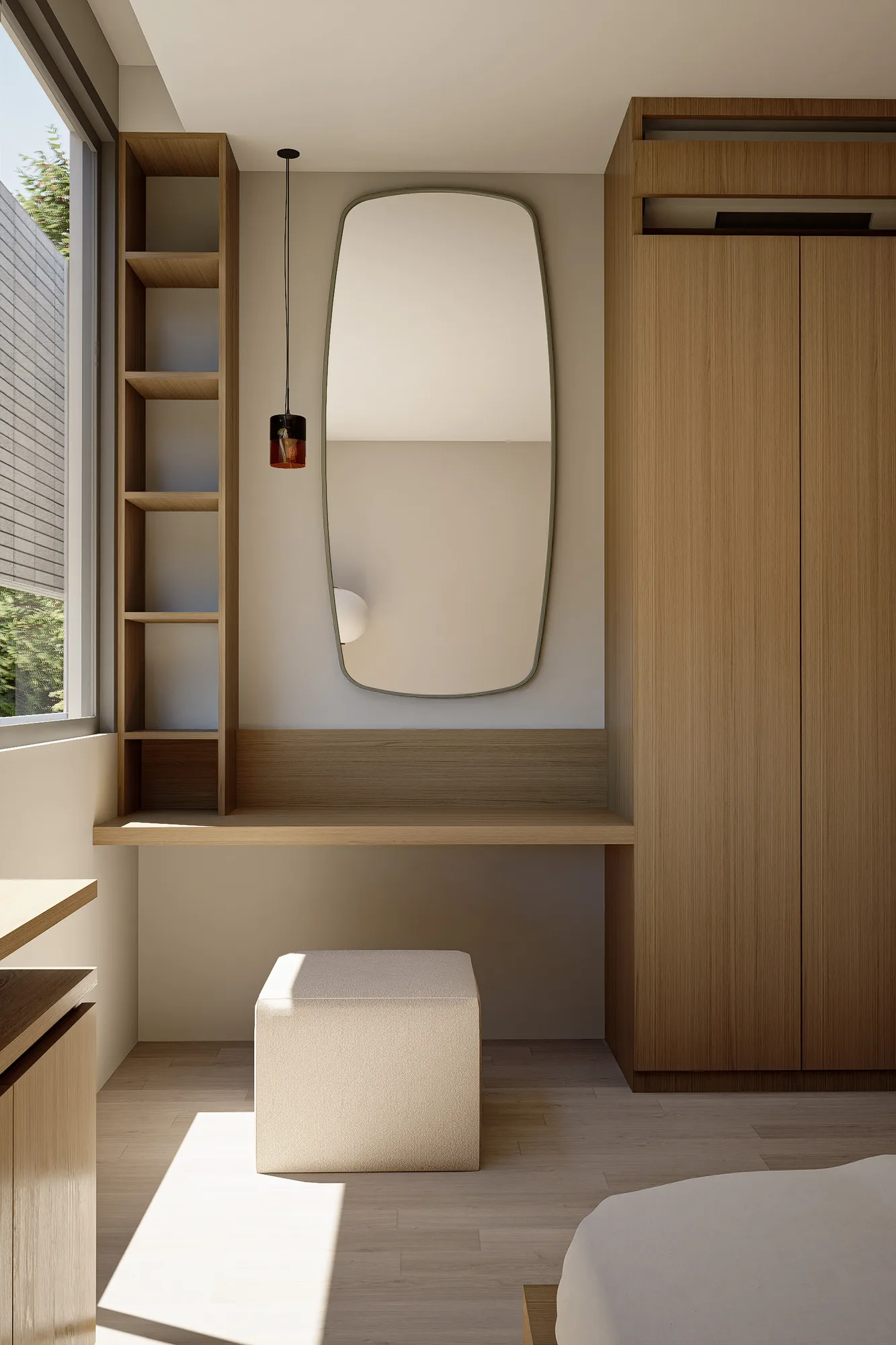 A tall oval mirror hangs above a built-in dressing table, flanked by open shelving and a wardrobe.