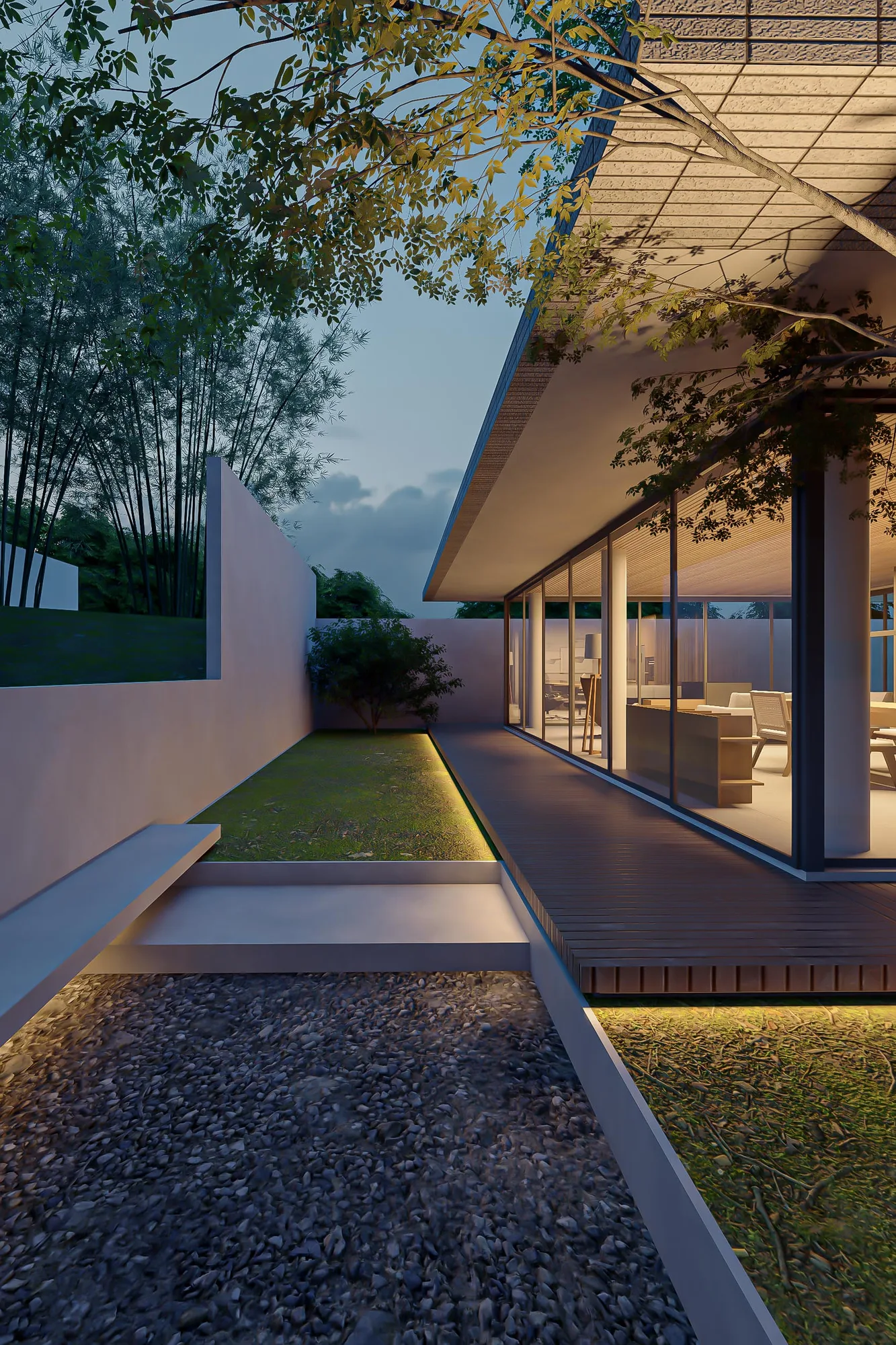 At dusk, a stepped lawn edged with underlit grass leads along the deck toward a lit study, bamboo rising against the darkening sky.