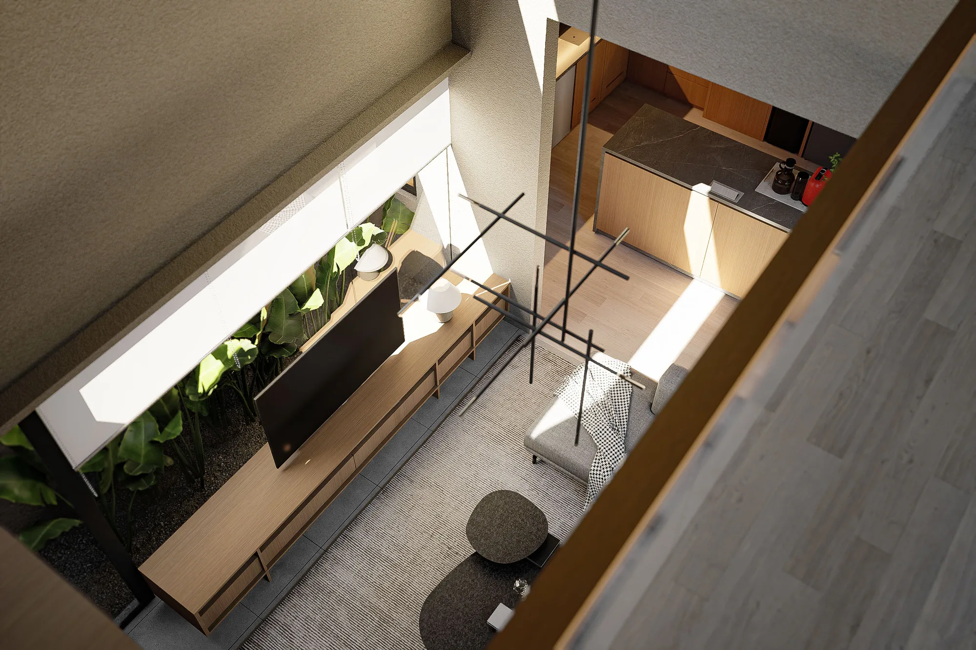Overhead view into the double-height living room, showing the TV console and banana-leaf planting beneath a hanging light fixture.