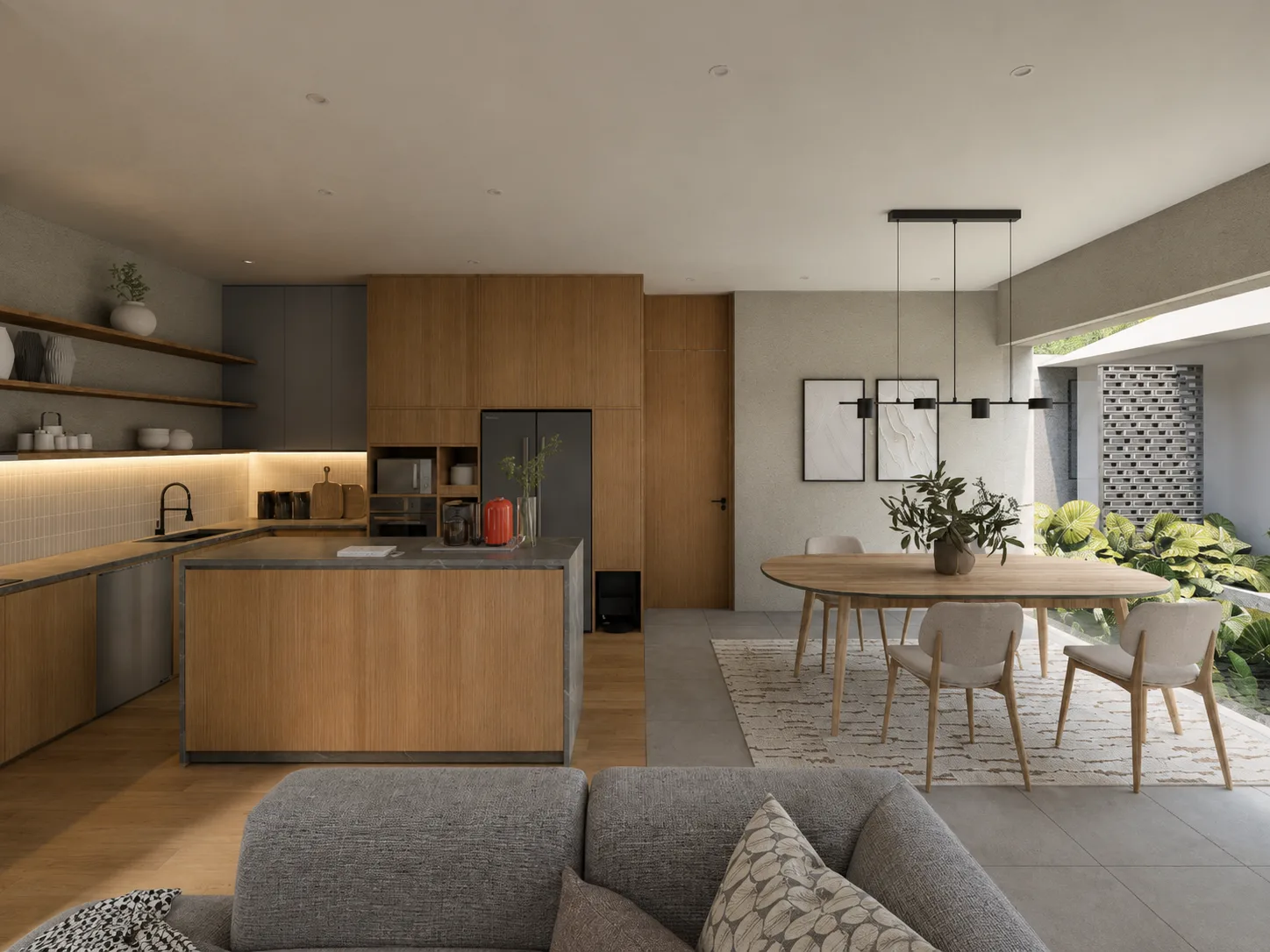 Open kitchen with grey lower cabinets and oak upper units, the marble-topped island facing an oval dining table lit by a linear pendant.