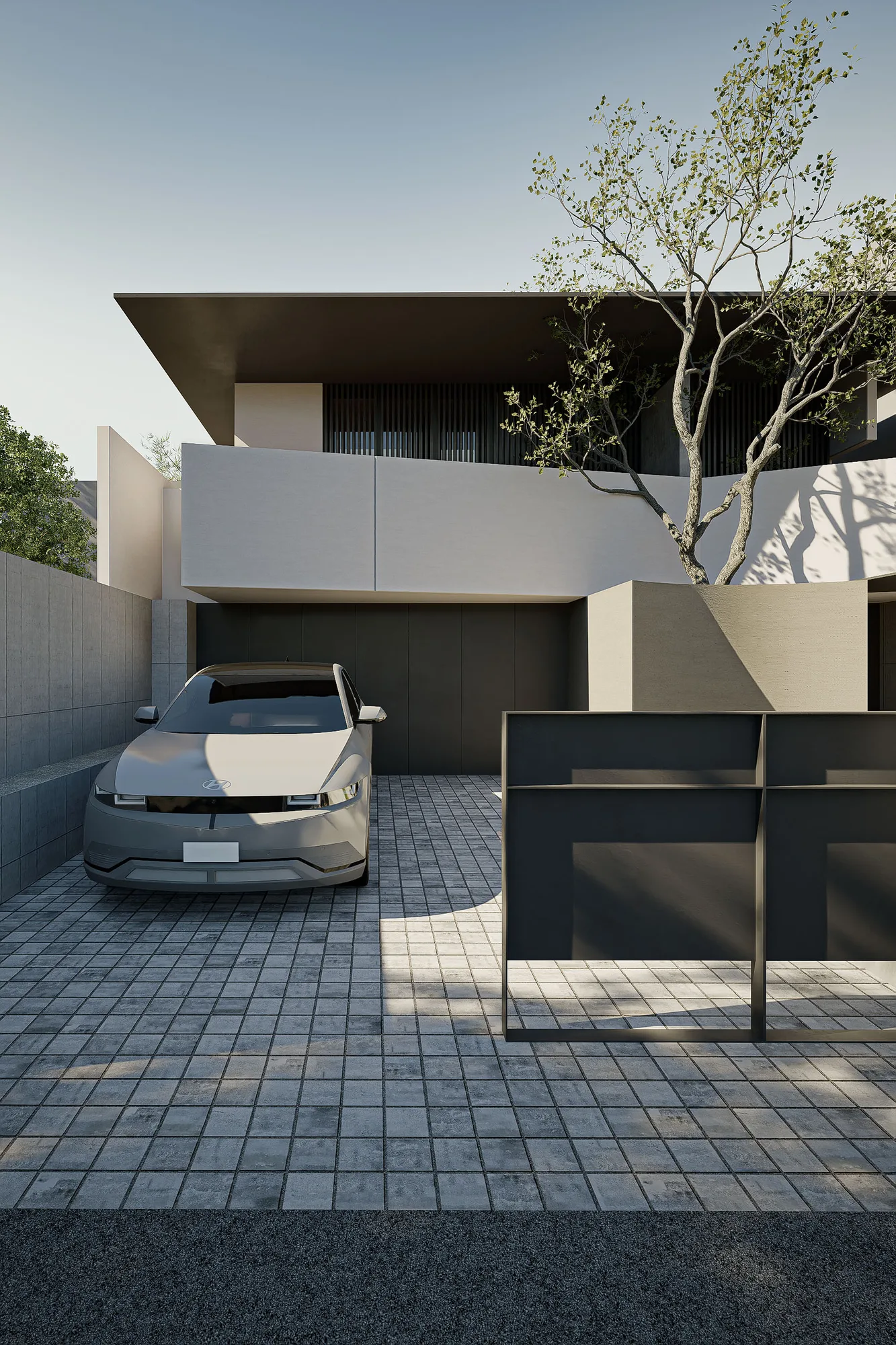 Front gate and driveway of FS House framed by the concrete-block boundary wall and the pale cantilevered upper volume.