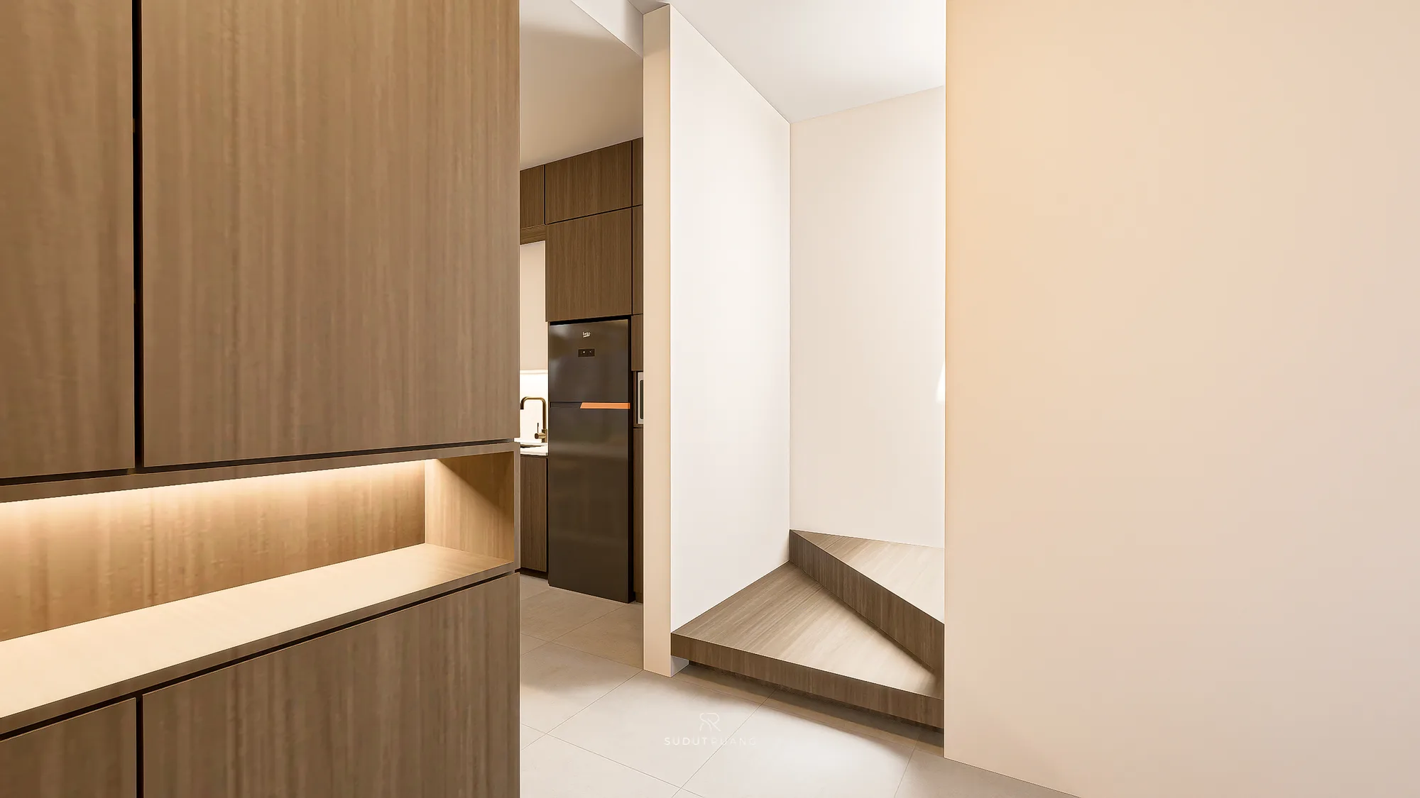 A wood-clad staircase turns beside KF House's entry corridor, with the kitchen's dark refrigerator visible through the doorway beyond.