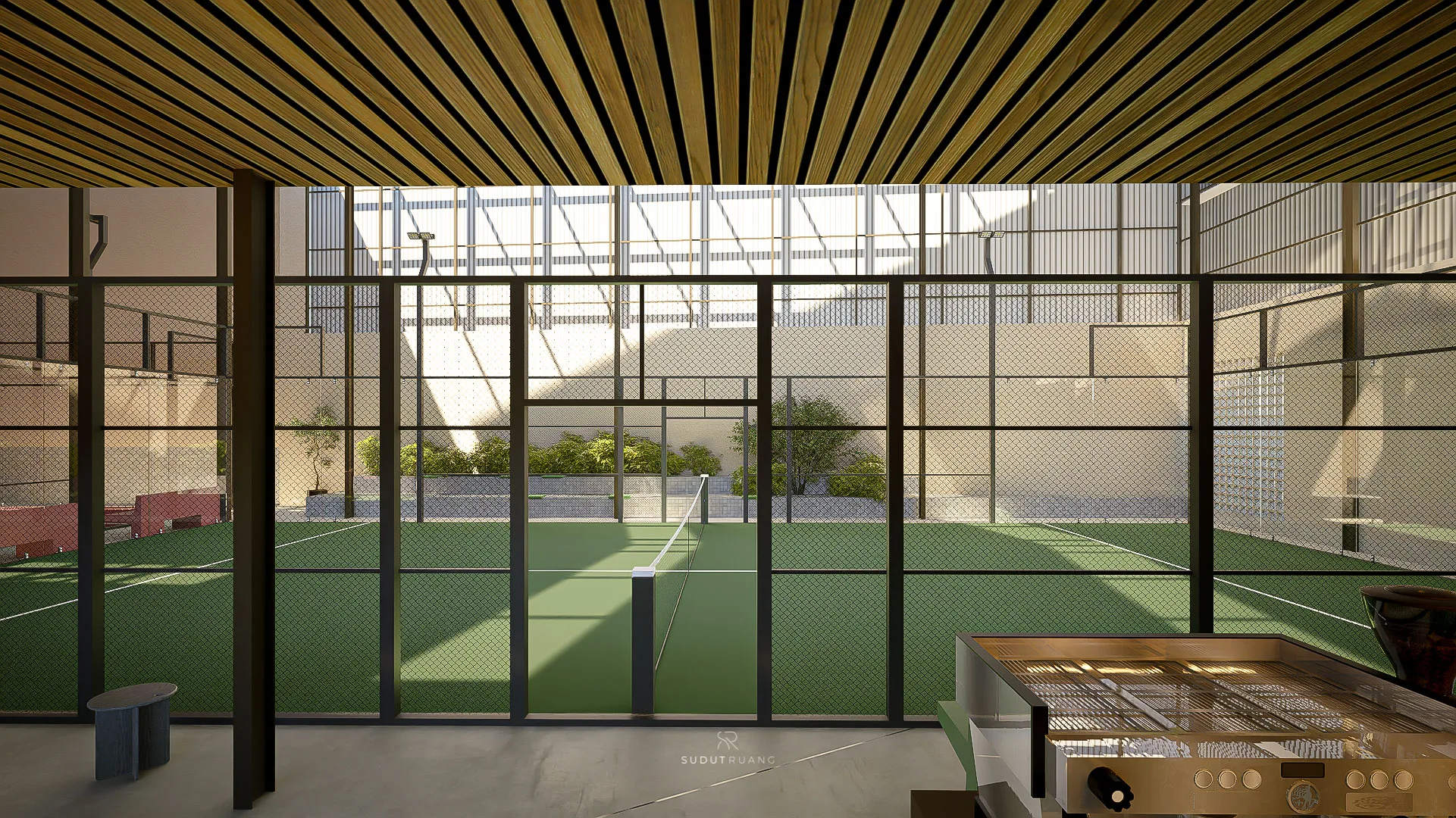 The court seen through its mesh fencing, the reception counter and coffee machine in the foreground.
