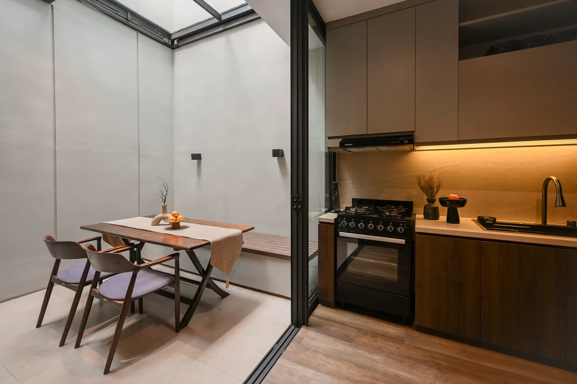 Dining area opening directly onto the kitchen's gas range and cabinetry.