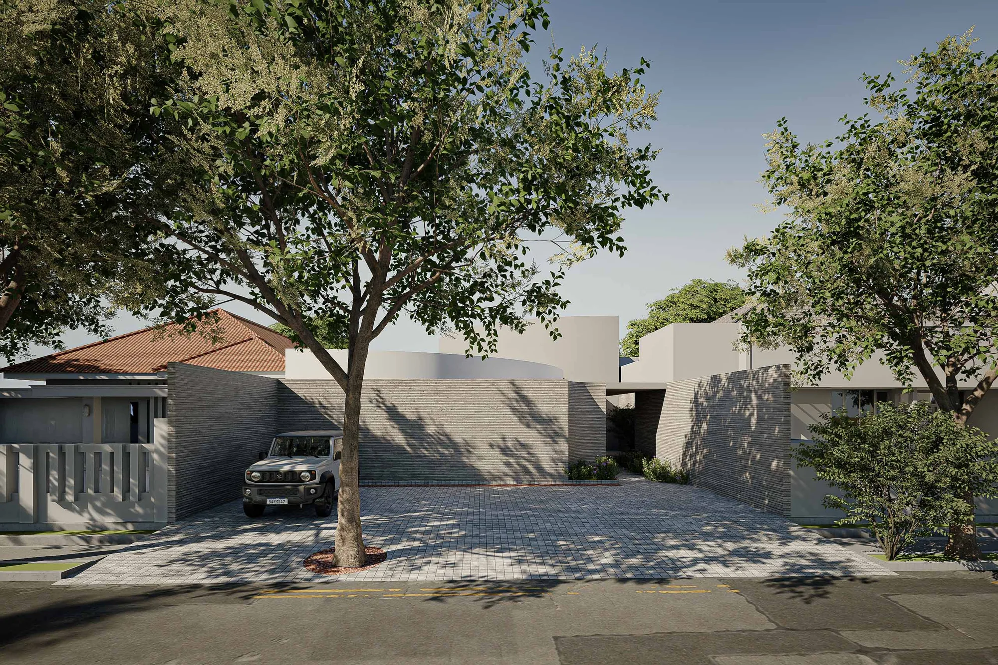 Street view of Pilates and Daycare's board-formed exterior wall and covered entry beneath overhanging trees.