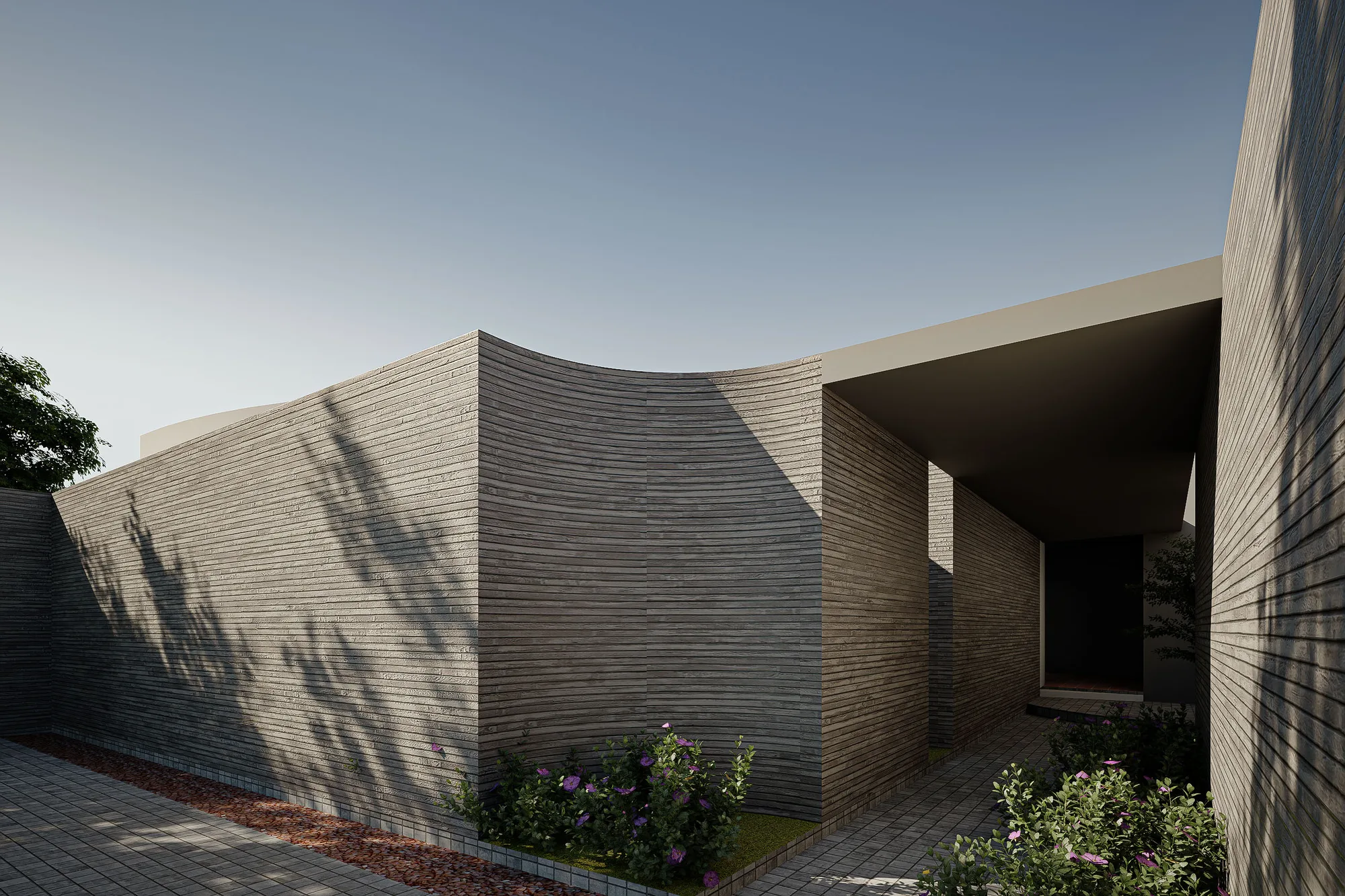Curved corner of the entry alley where board-formed cladding meets the cantilevered entrance canopy.