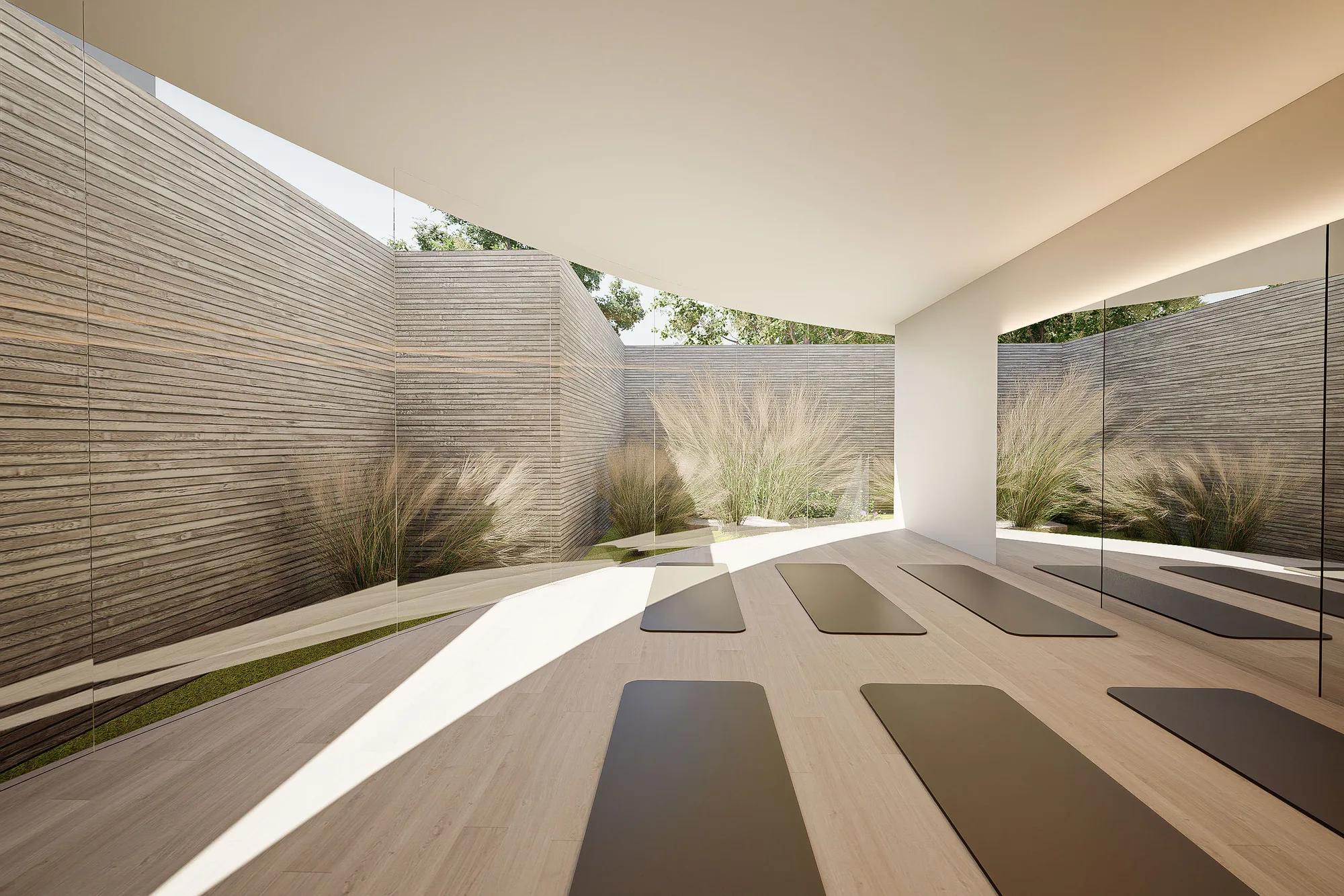 Curved white ceiling sweeping over the courtyard, framing a doorway and the pilates area entrance below.