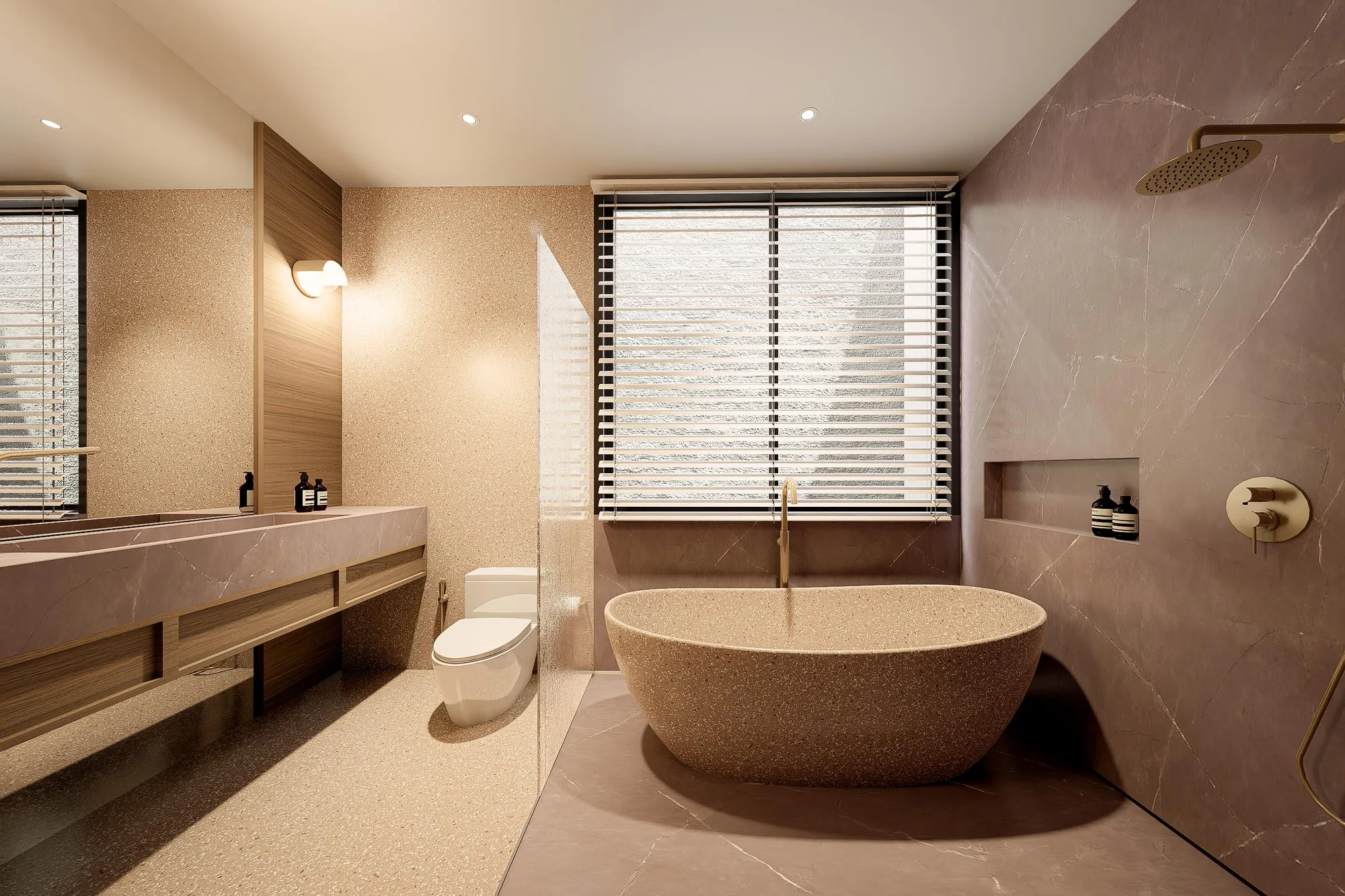 Primary bathroom with a terrazzo freestanding tub, brass fittings, and a louvred window filtering daylight.