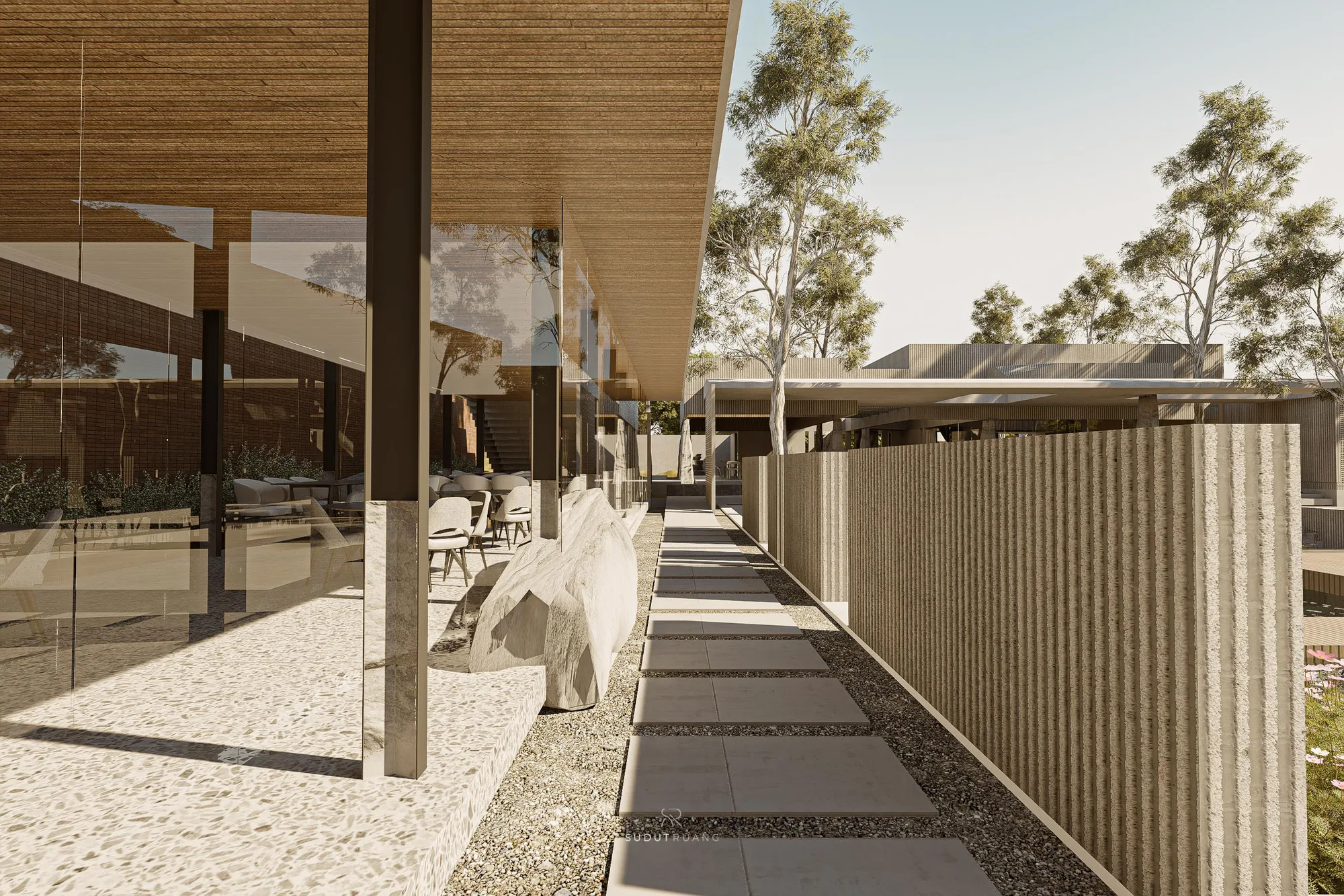 A long reflecting pool bordered by timber decking, the dining pavilion catching the golden-hour light beyond.
