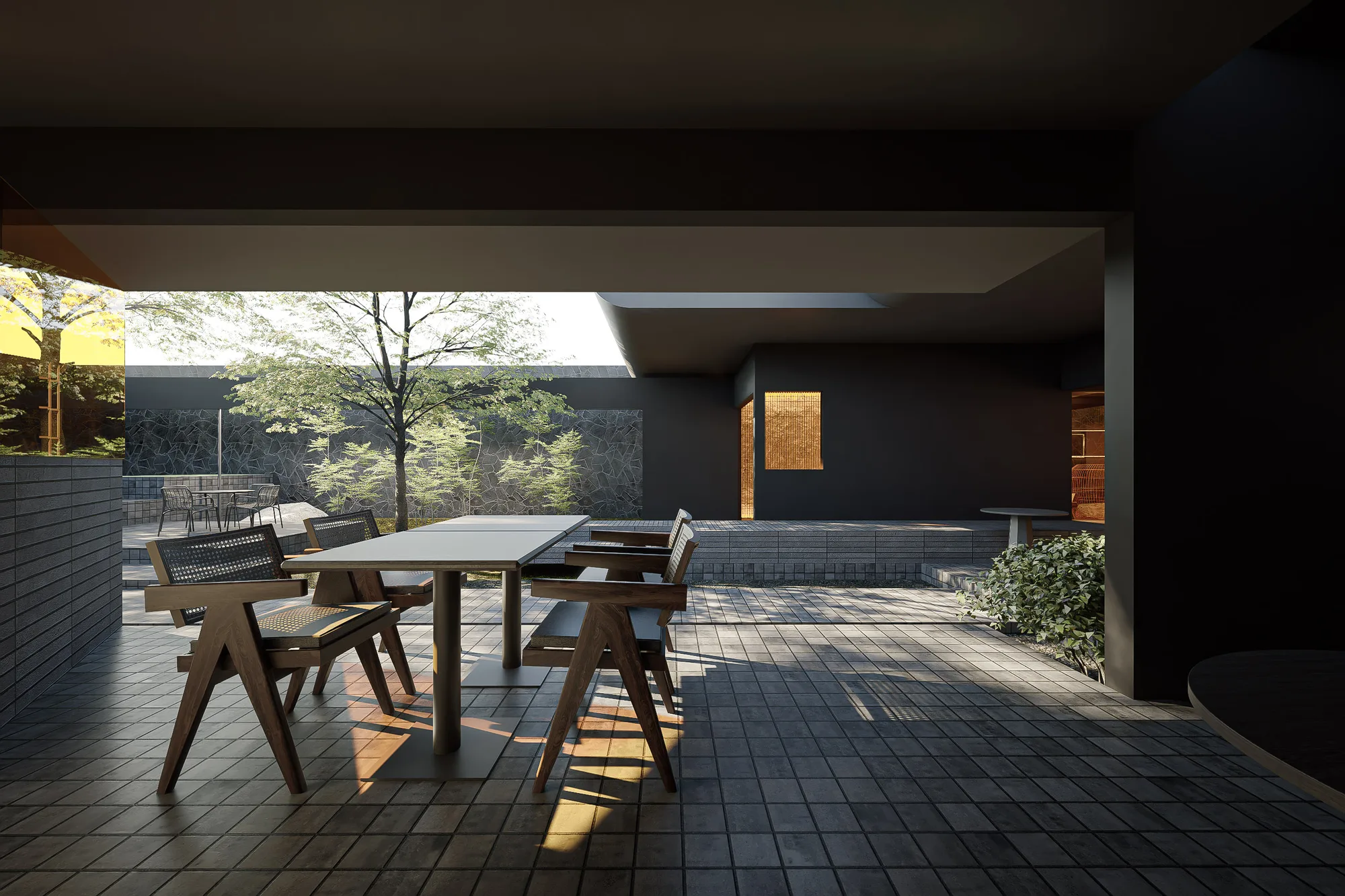 An overhead view of the stepped stone terrace above the gravel courtyard, the gold-mirrored volume at its edge.