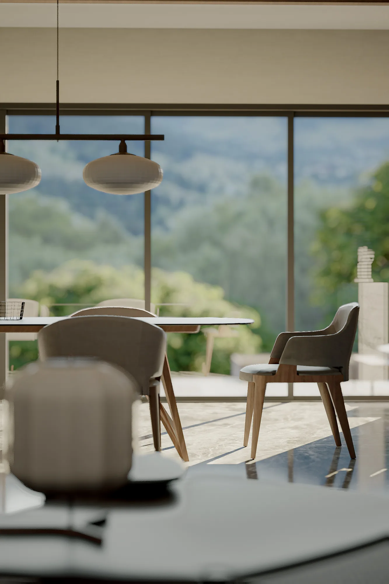 Dining chairs against a blurred backdrop of forested mountains seen through floor-to-ceiling glass.