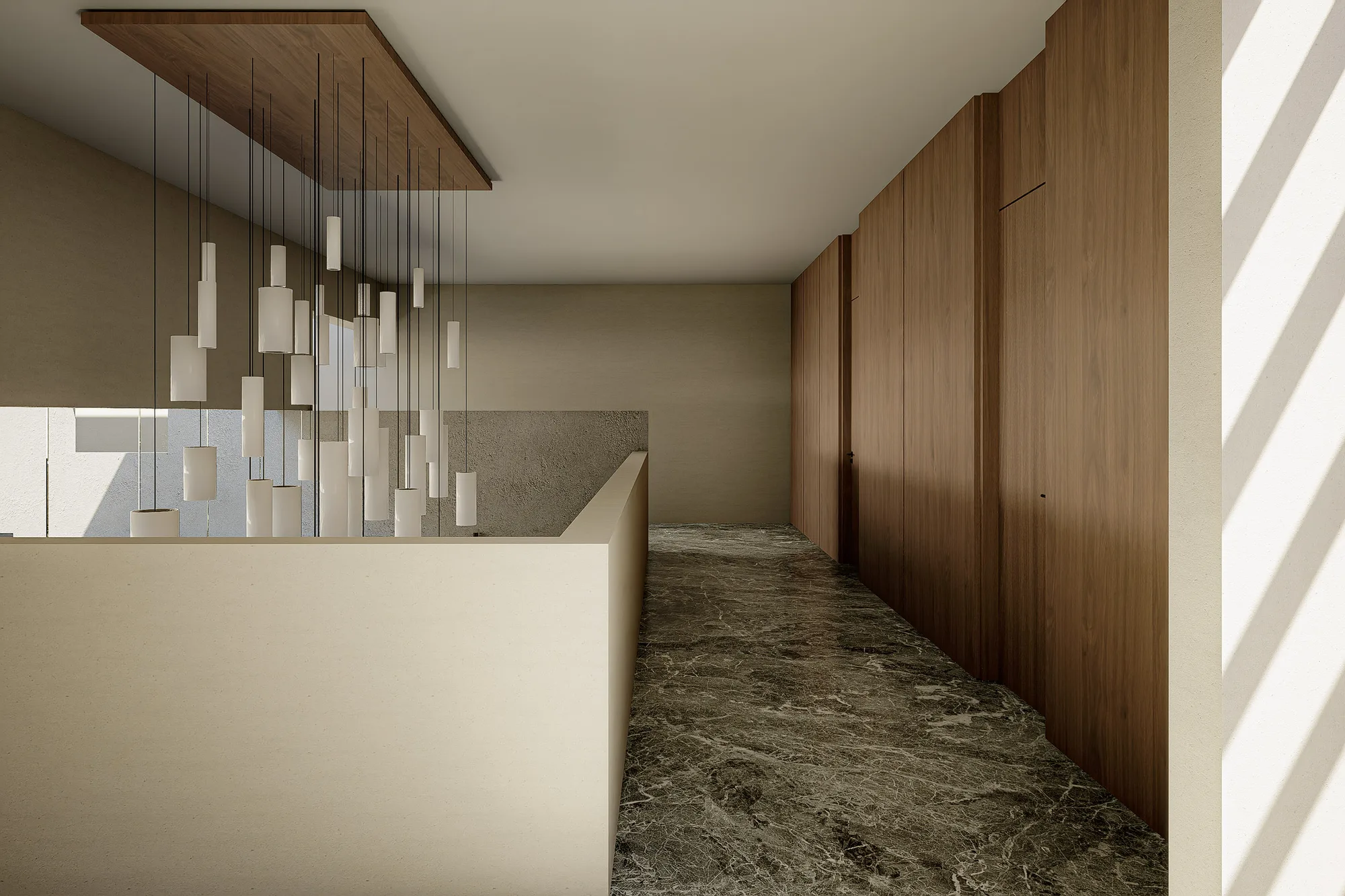 Corridor lined in walnut paneling beneath a cluster of pendant lights hanging over the stairwell void.