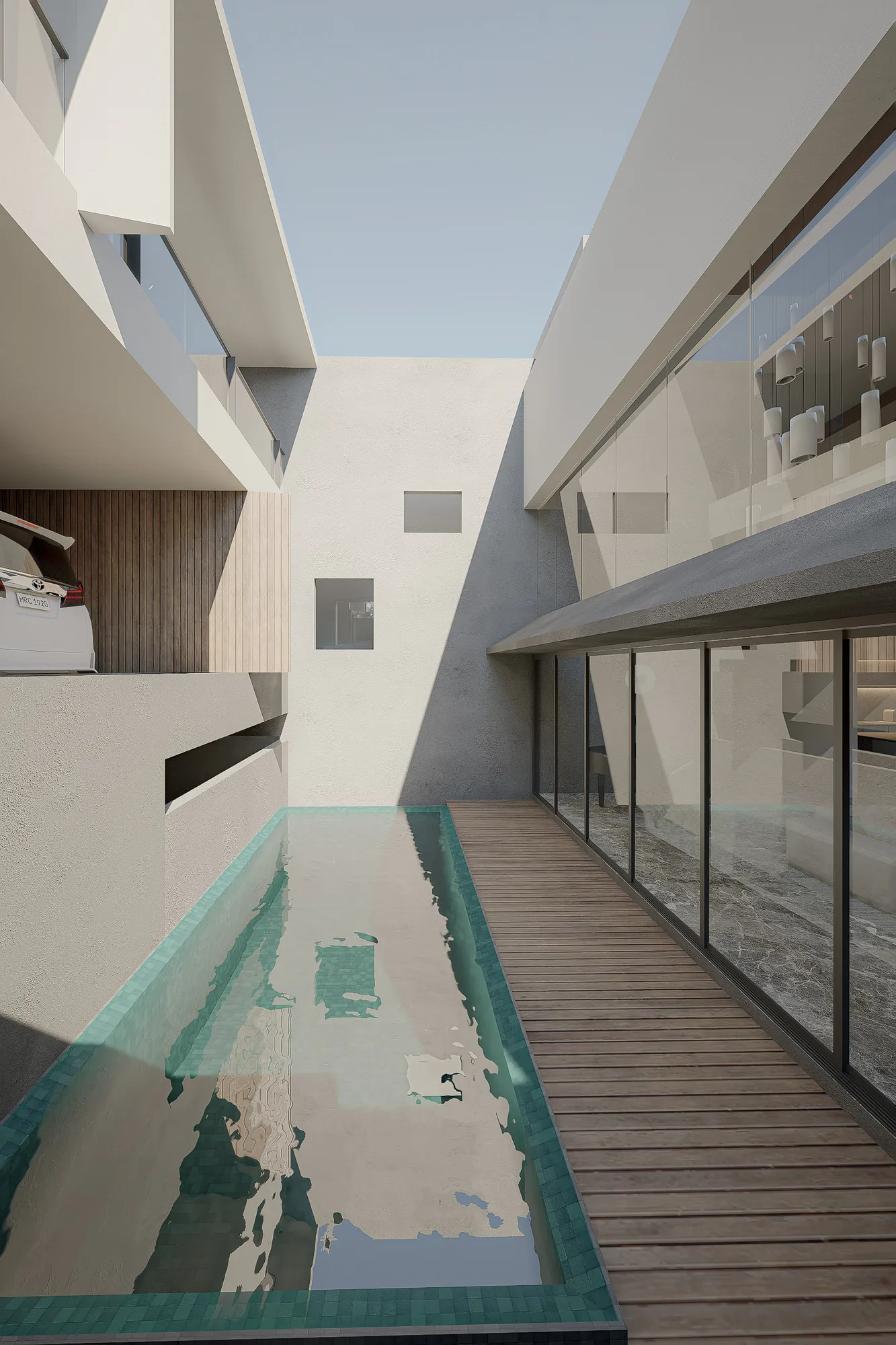 Lap pool running the length of the narrow side courtyard, a timber deck separating it from the glazed living room wall.