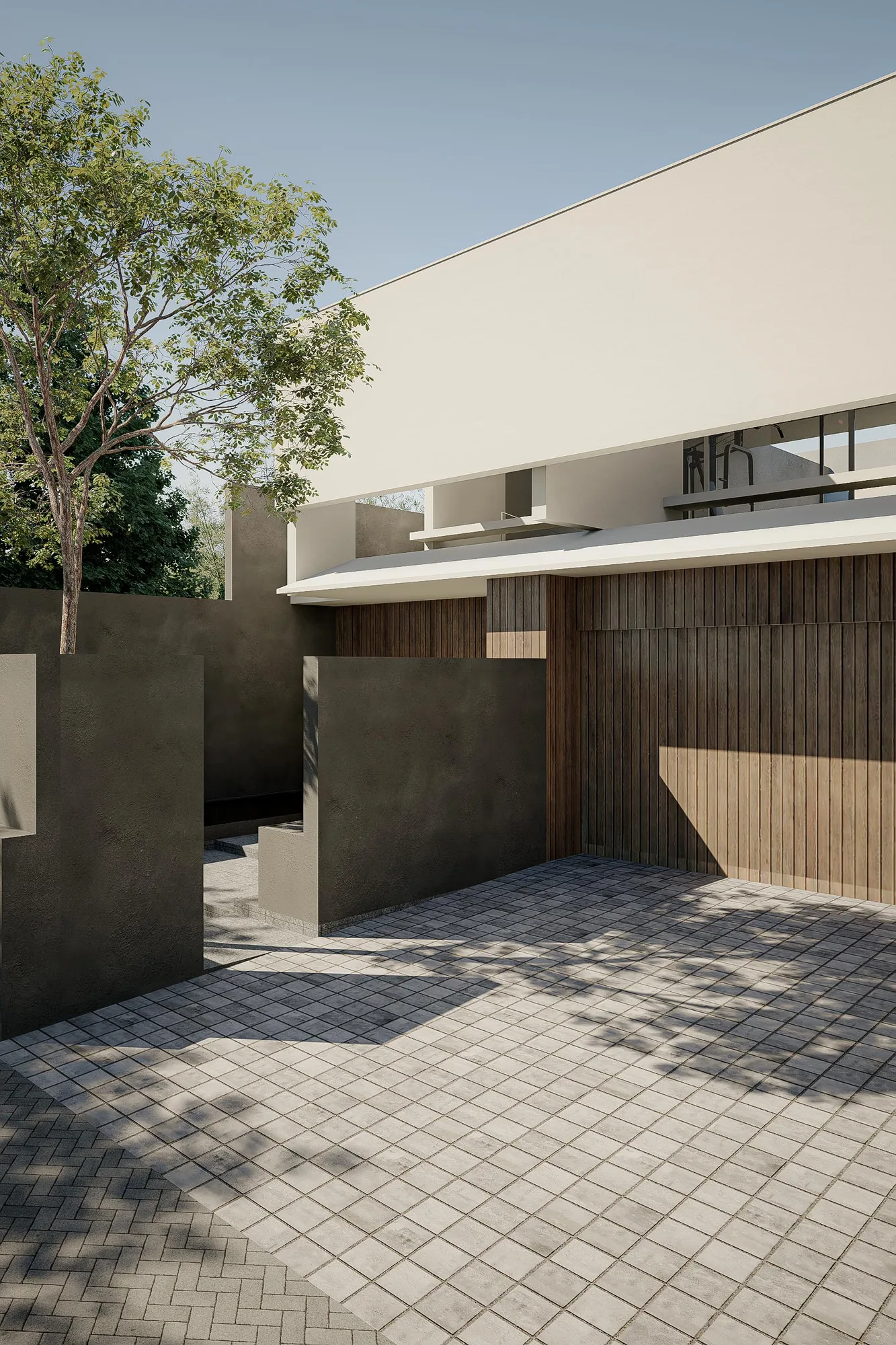 Entry courtyard with a timber-slatted garage wall and a dark concrete partition wall shading the paved approach.