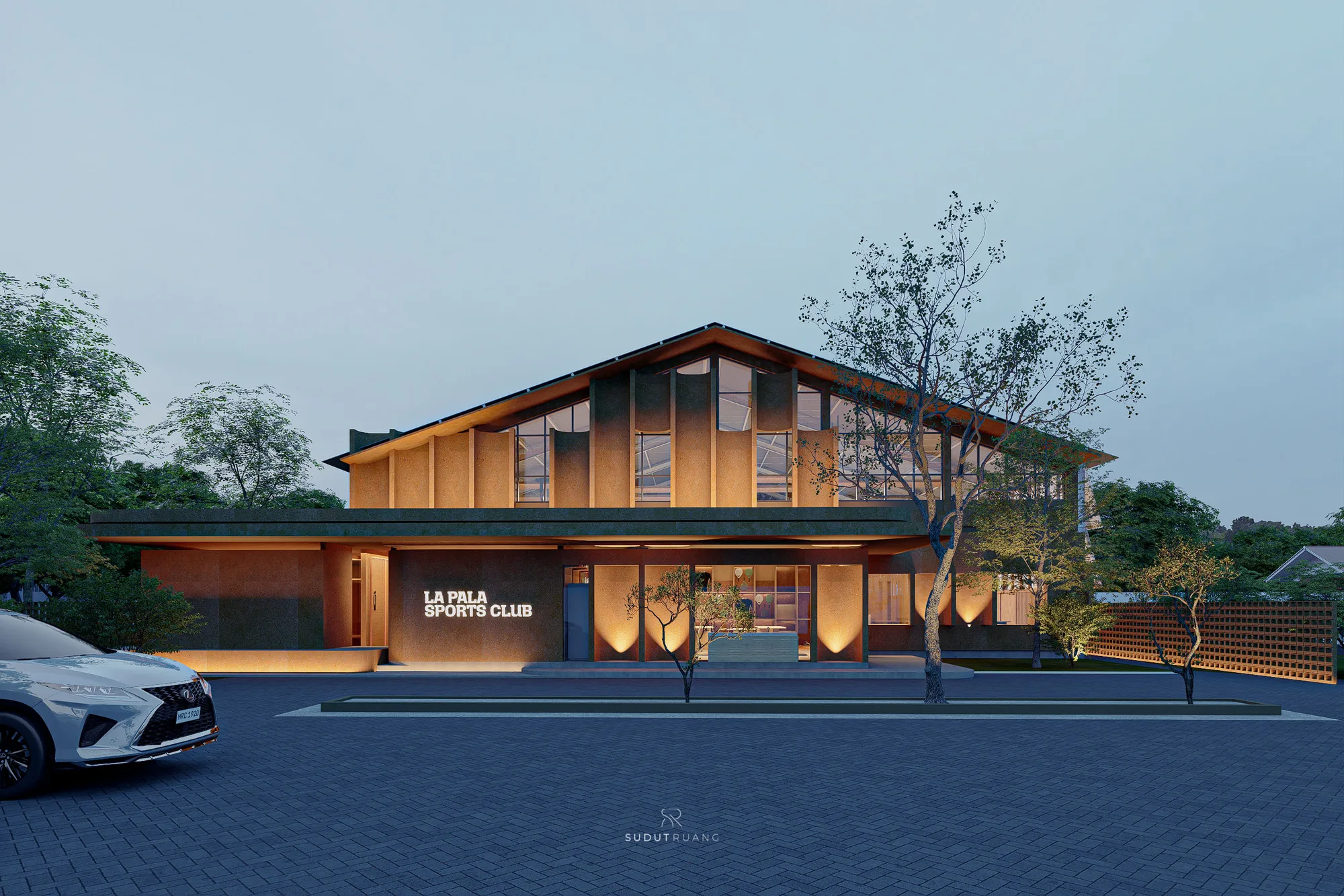 Terra Sports Club's terracotta-clad upper volume, ribbed with undulating vertical columns, glows at dusk above its glazed ground-floor entry.